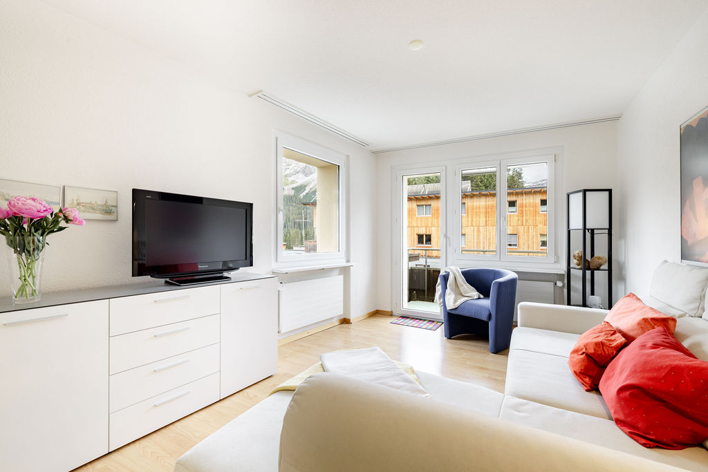 Living room with TV and balcony access